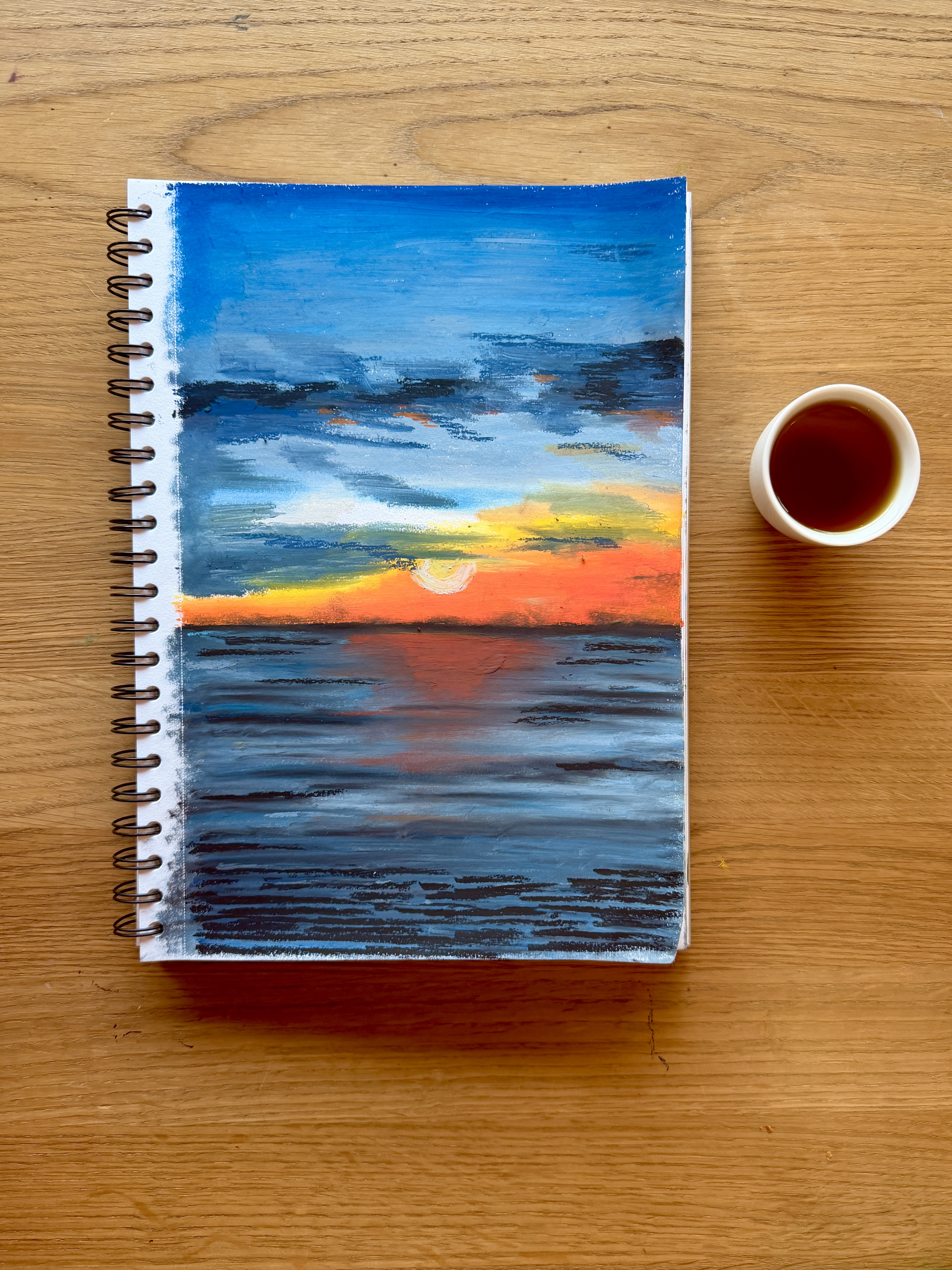 Sunset over water oil pastel sketch