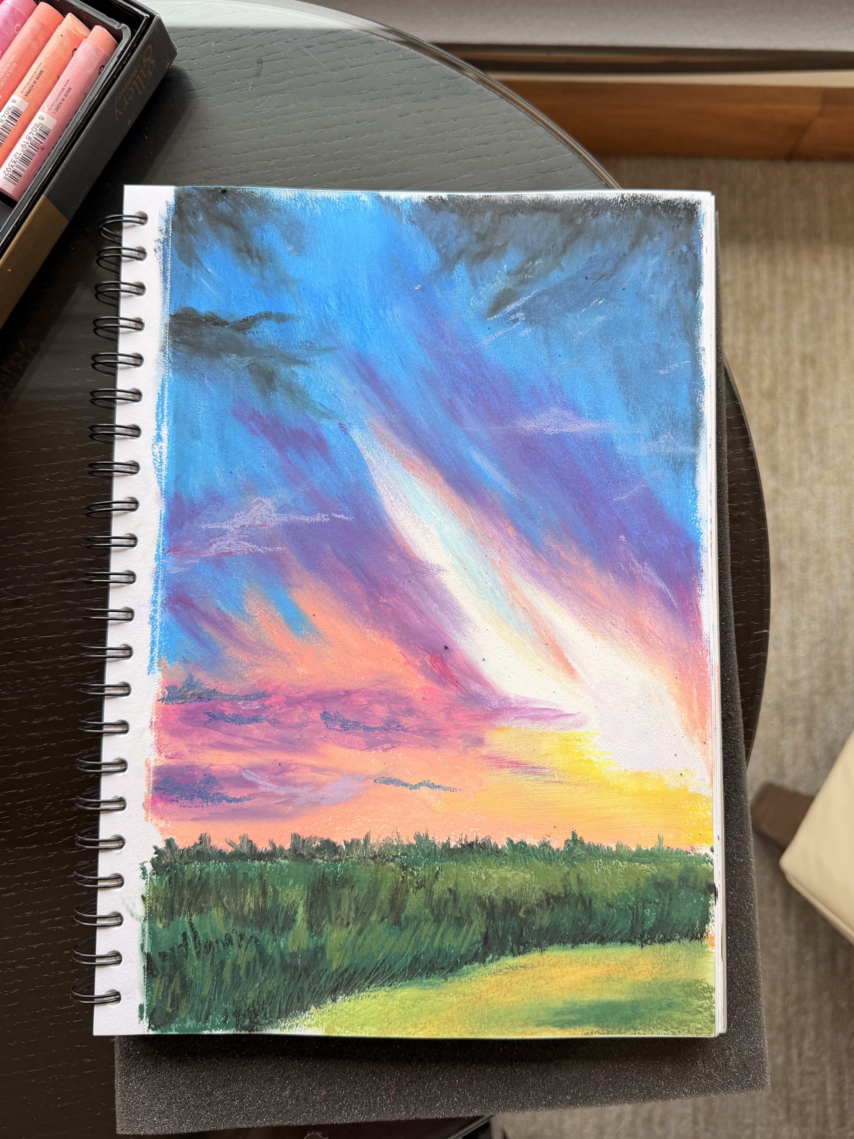 Colorful sunset over a field oil pastel sketch